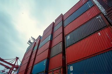 Shipping containers stacked at a port, symbolizing export services.